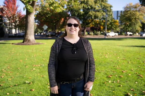 Person standing outside on grass Person standing outside on grass