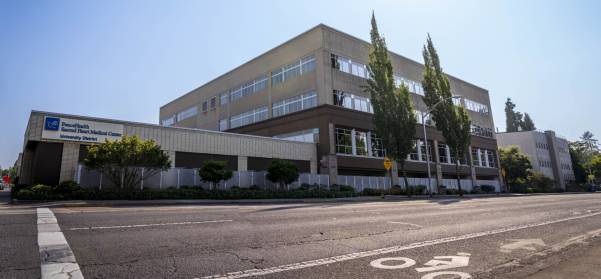 Person standing outside in front of trees Person standing outside in front of trees