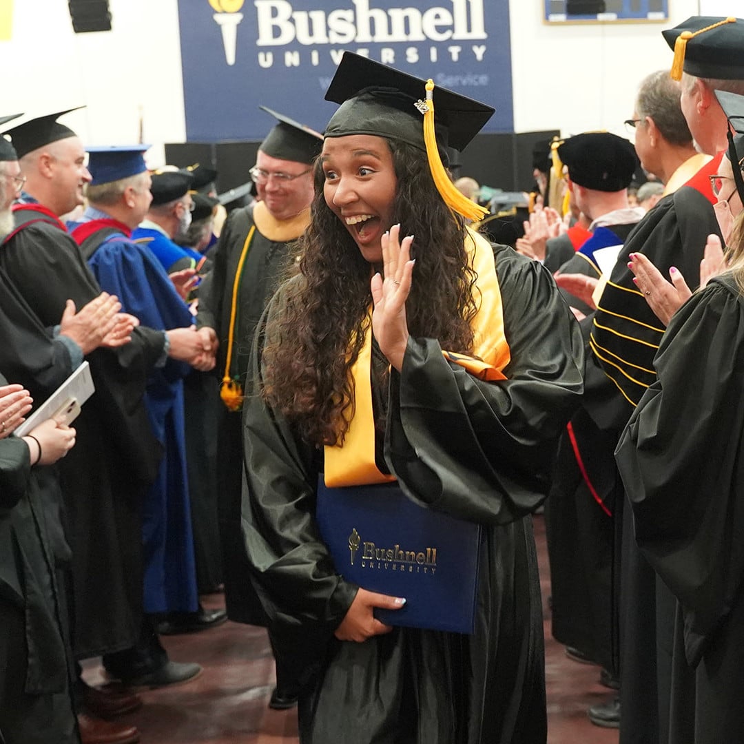female student celebrating at commencement