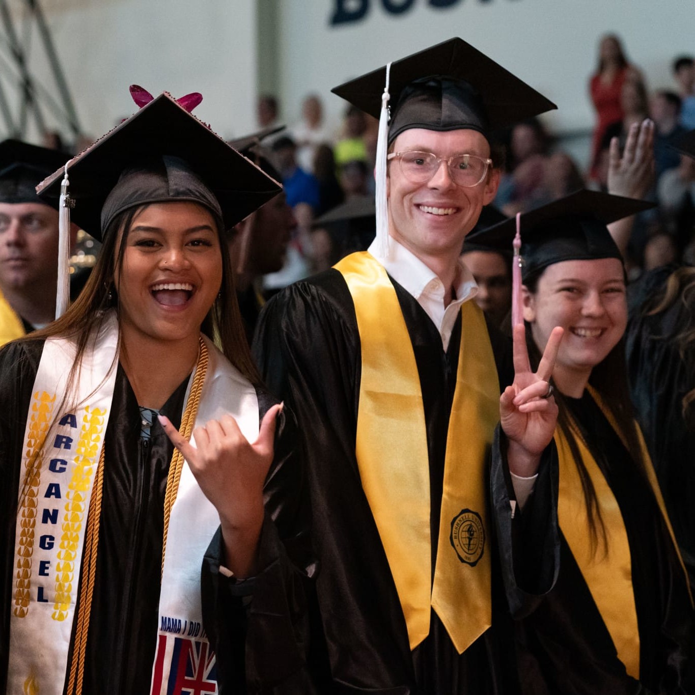 people posing to the camera at commencement