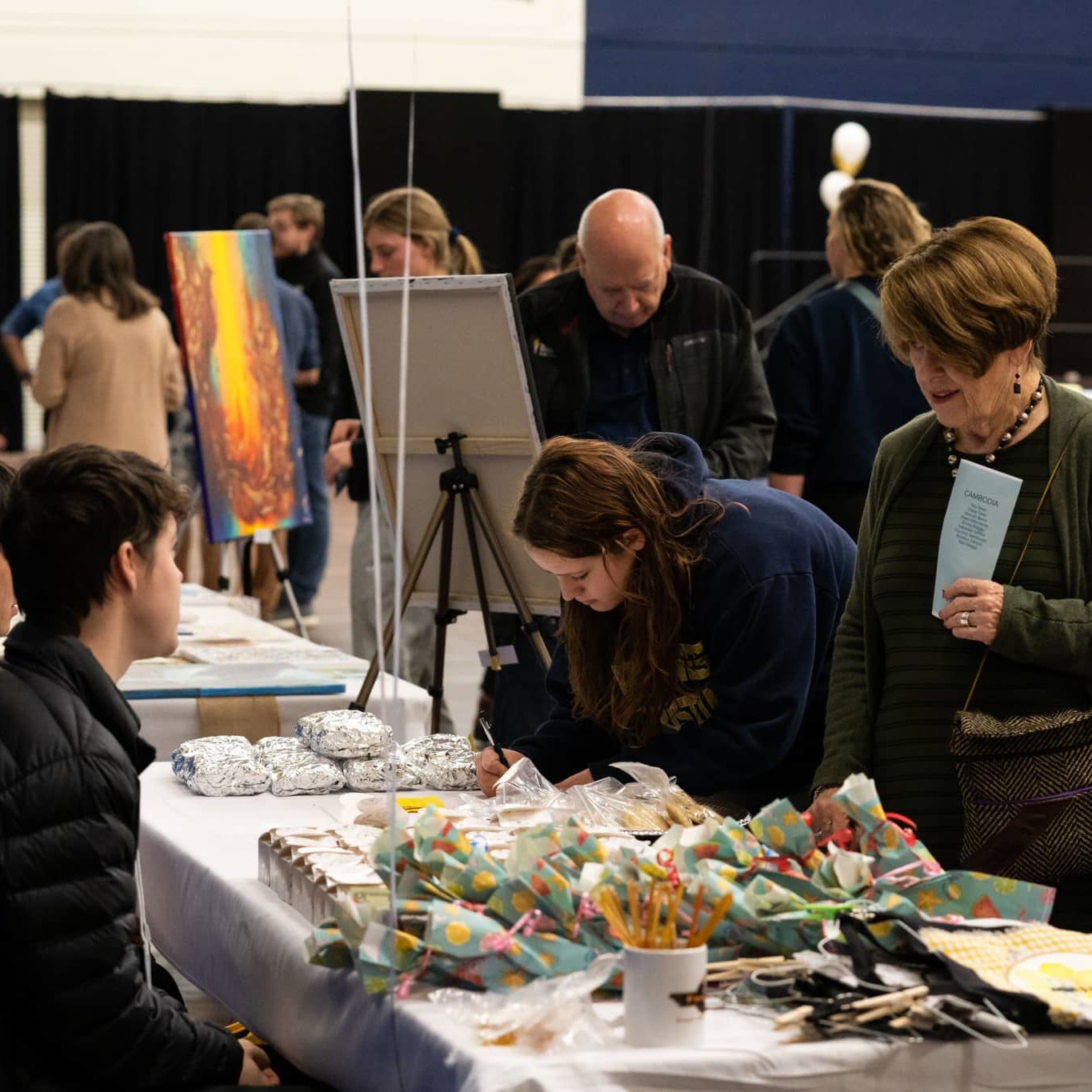 people purchasing goods at a table