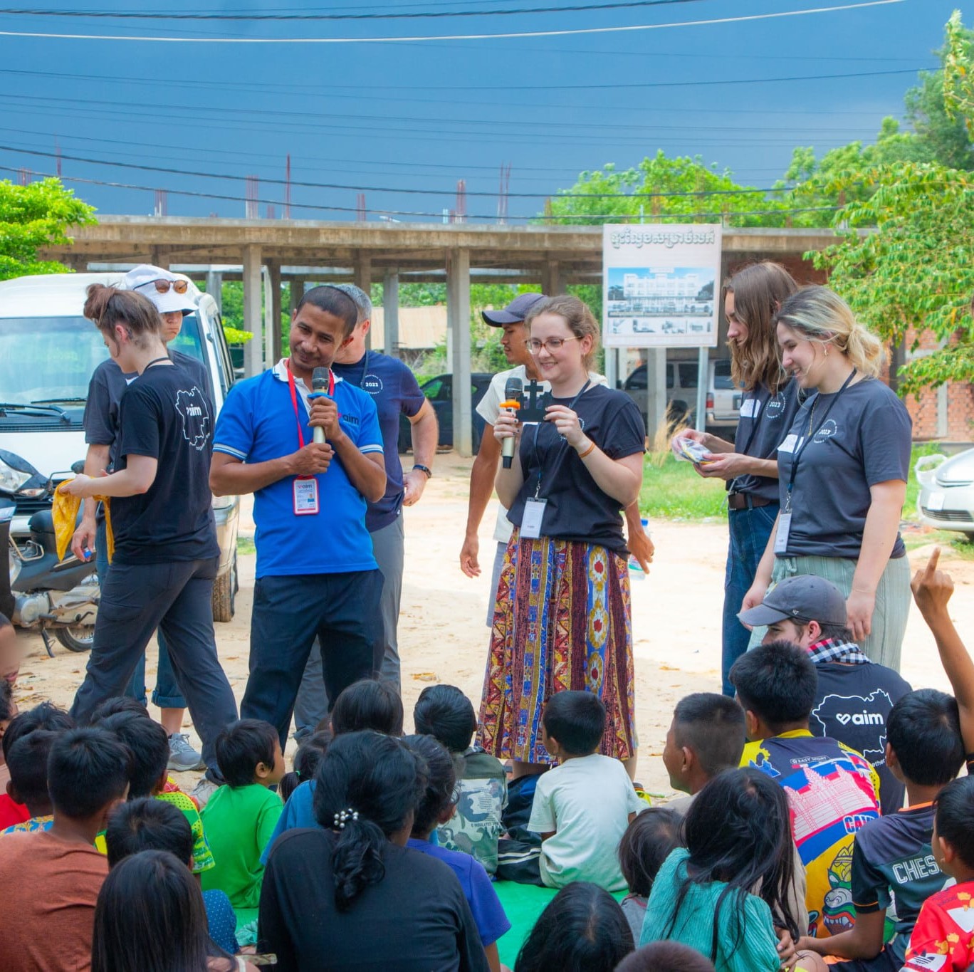 people talking to group of children