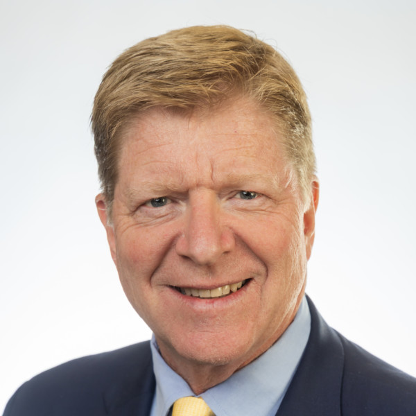 person speaking in front of podium