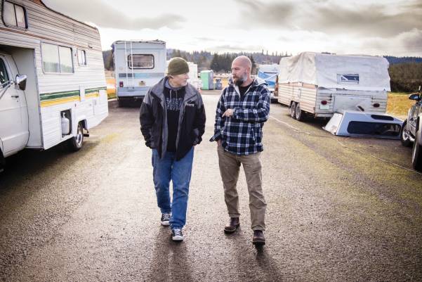 Two men walking on a road