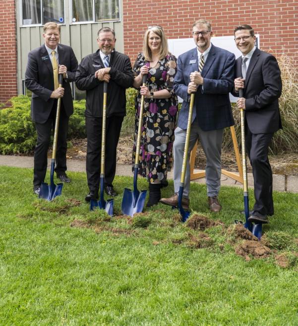 Group of people holding shovels