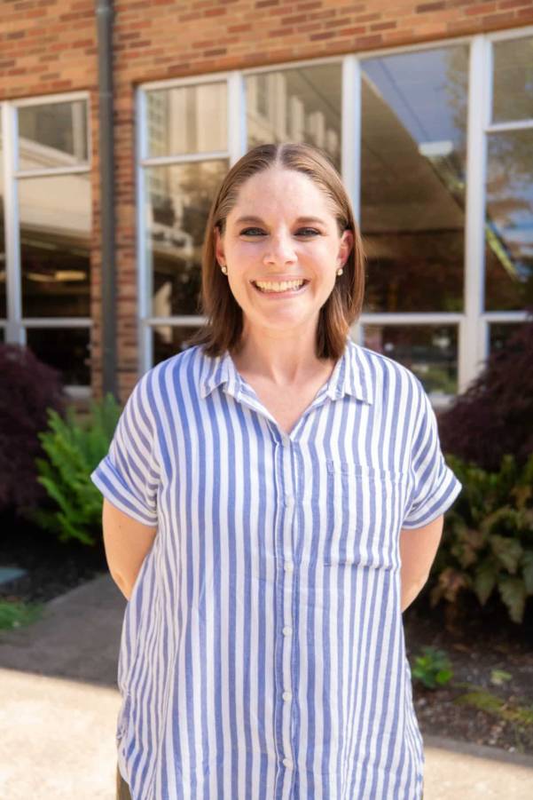 staff member standing outside a campus building at Bushnell University