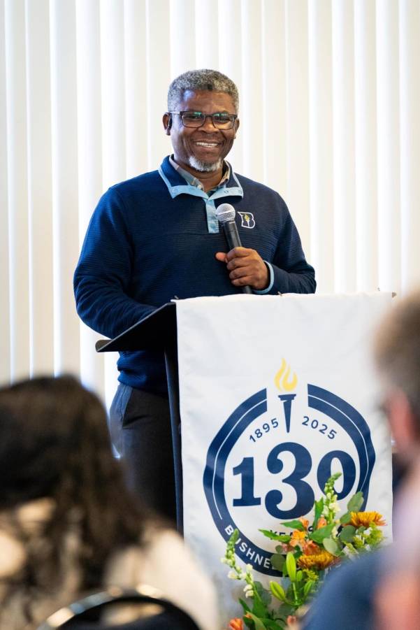 Man speaking into mic at podium