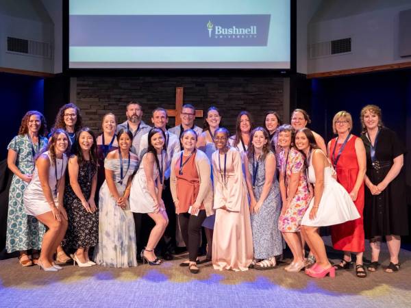 Female nursing faculty posing with student at ceremony 