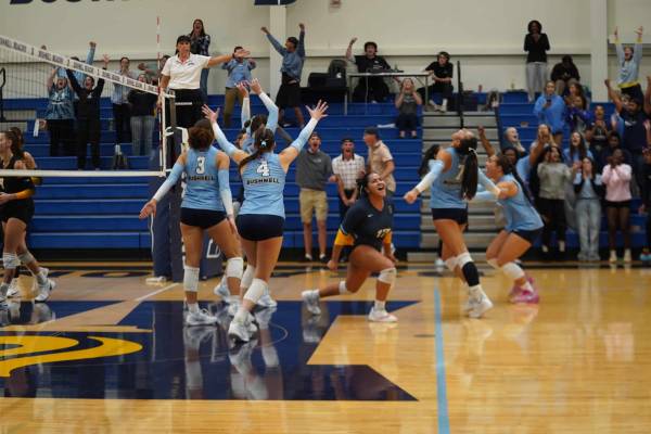 A group of volleyball players celebrating