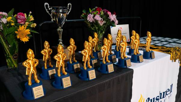 Person standing outside in front of trees